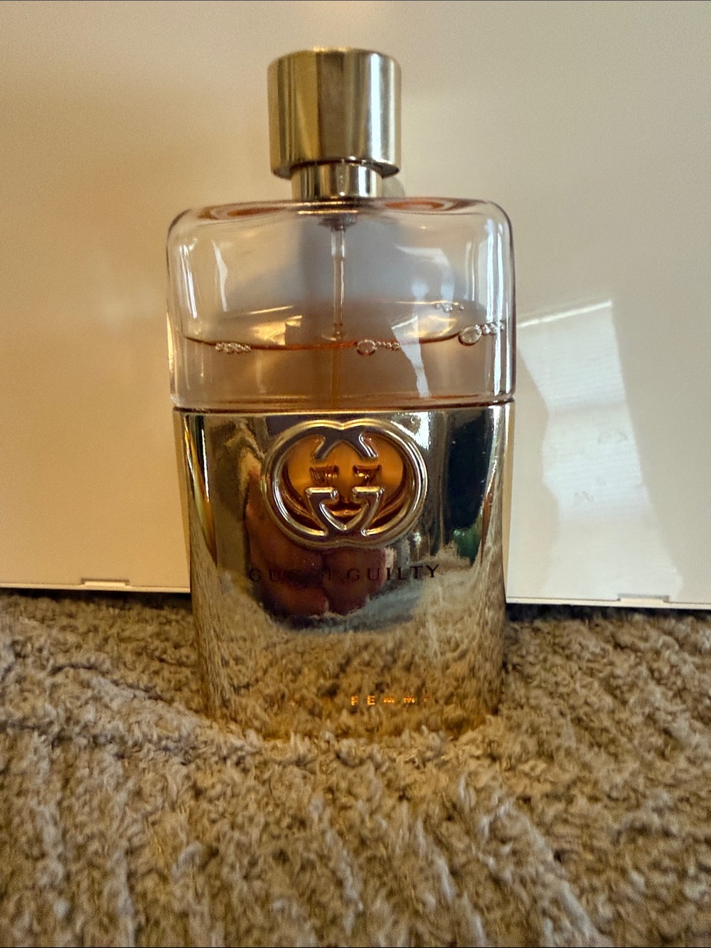 Gucci metallic gold and clear logo perfume bottle